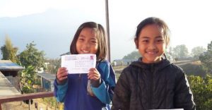 child holding the letter she received from her sponsor