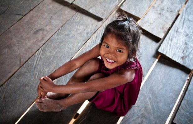 Smiling Cambodian girl in her wooden house
