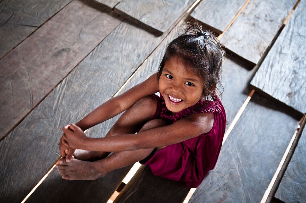 Smiling Cambodian girl in her wooden house