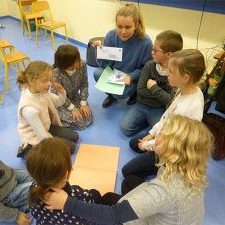 A facilitator explaining something to the children