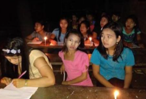 Karen pupils studying by candlelight in Myanmar